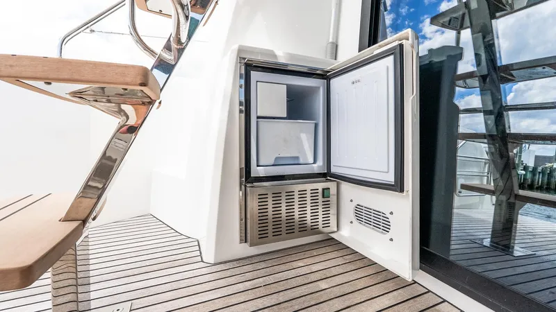  Yacht Photos Pics Open mini fridge on 2022 Prestige 460 Fly yacht deck, showcasing modern design.