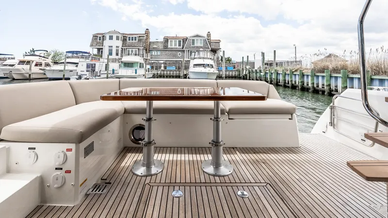  Yacht Photos Pics Luxury 2022 Prestige 460 Fly yacht deck with seating and table, docked at marina.