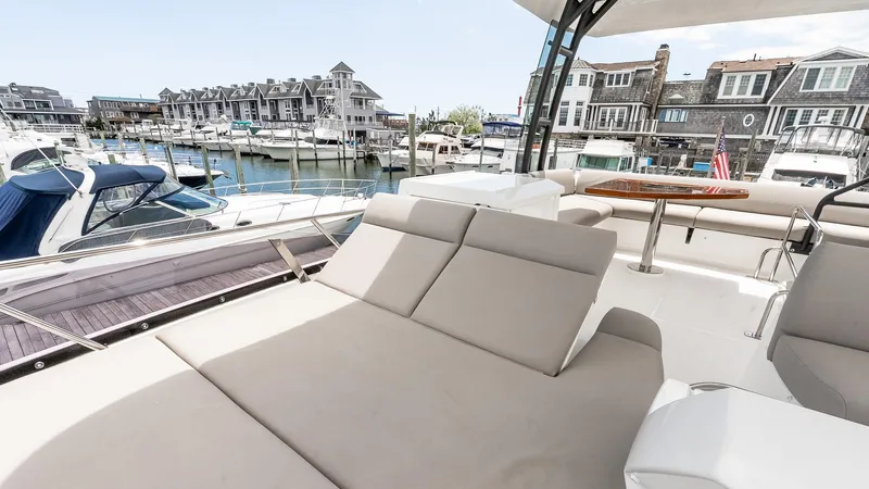  Yacht Photos Pics Prestige 460 Fly 2022 yacht with luxurious deck seating in a marina setting.