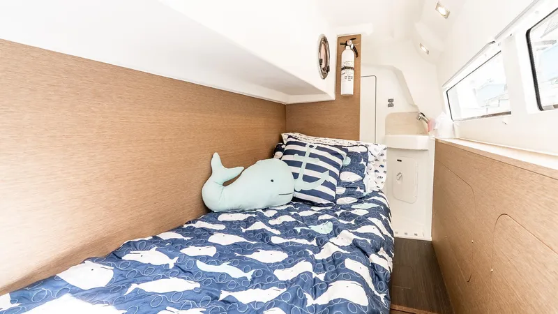  Yacht Photos Pics Cozy cabin interior of 2022 Prestige 460 Fly yacht with nautical-themed bedding.