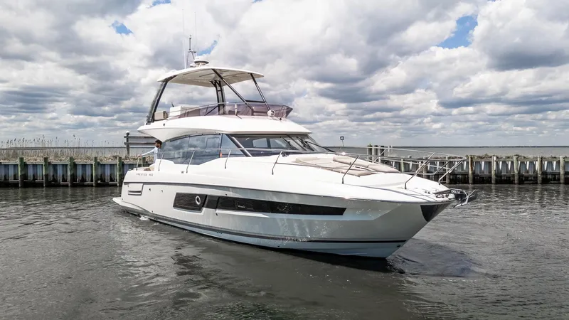  Yacht Photos Pics 2022 Prestige 460 Fly yacht on water under cloudy sky.