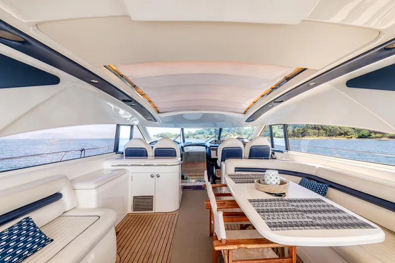 Princess V65 Yacht Photos Pics Luxurious interior of 2003 Princess V65 yacht with elegant seating and dining area.