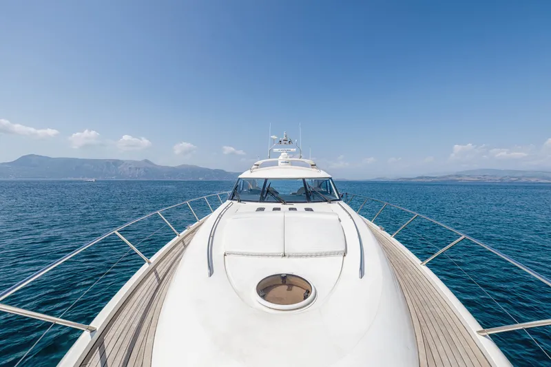 Princess V65 Yacht Photos Pics Front view of a 2003 Princess V65 yacht cruising on a clear blue sea.