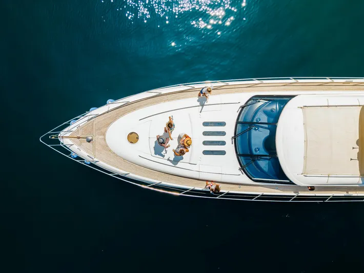 Princess V65 Yacht Photos Pics Aerial view of a 2003 Princess V65 yacht with people relaxing on deck.