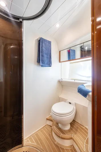 Princess V65 Yacht Photos Pics Luxurious bathroom in 2003 Princess V65 yacht with modern fixtures and elegant design.