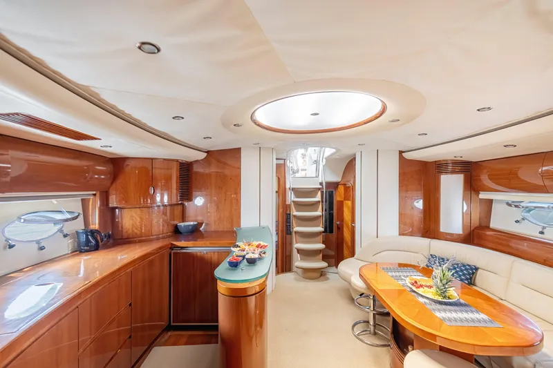 Princess V65 Yacht Photos Pics Luxurious interior of a 2003 Princess V65 yacht with elegant wood finishes and modern amenities.