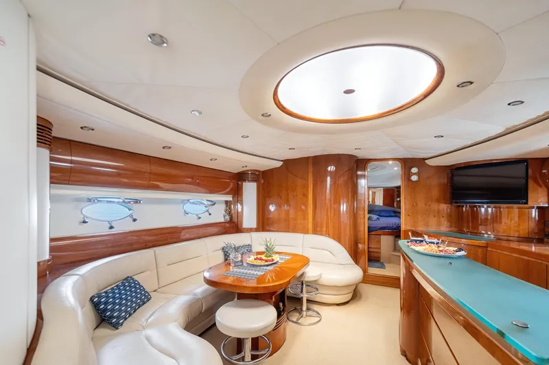 Princess V65 Yacht Photos Pics Luxurious 2003 Princess V65 yacht interior with elegant wood finishes and plush seating.