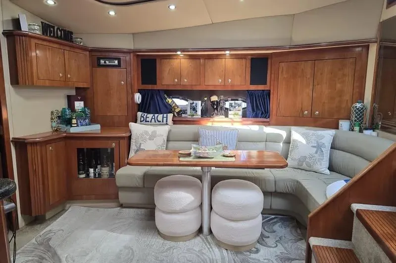  Yacht Photos Pics Luxurious 2005 Cruisers Yachts 440 Express interior with elegant wood cabinetry and cozy seating.