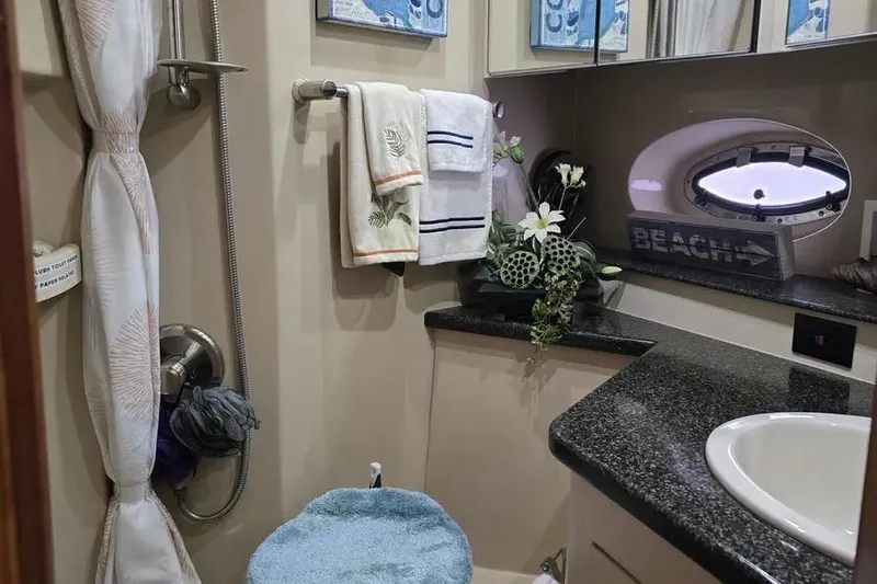  Yacht Photos Pics Luxurious 2005 Cruisers Yachts 440 Express bathroom with elegant decor and modern amenities.