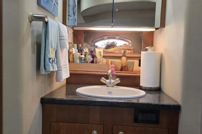  Yacht Photos Pics Luxurious 2005 Cruisers Yachts 440 Express bathroom with sink and toiletries.