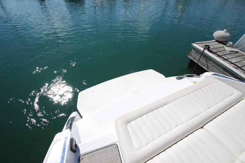  Yacht Photos Pics 2016 Cobalt R30 boat docked on calm water with sun reflecting.