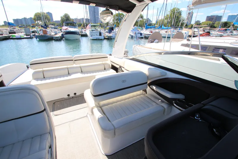  Yacht Photos Pics 2016 Cobalt R30 boat interior with white seating, docked in a marina.