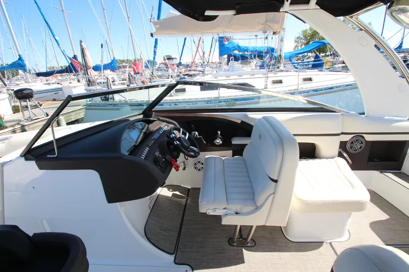  Yacht Photos Pics 2016 Cobalt R30 boat interior with helm and seating, docked at marina.