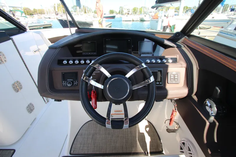  Yacht Photos Pics 2016 Cobalt R30 boat dashboard with steering wheel and control panel.