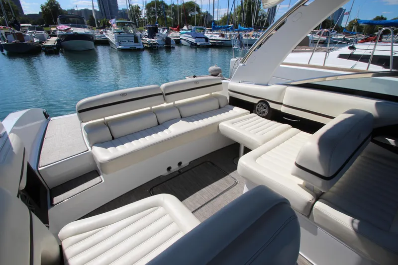  Yacht Photos Pics Luxurious 2016 Cobalt R30 boat interior with white seating, docked in a marina.