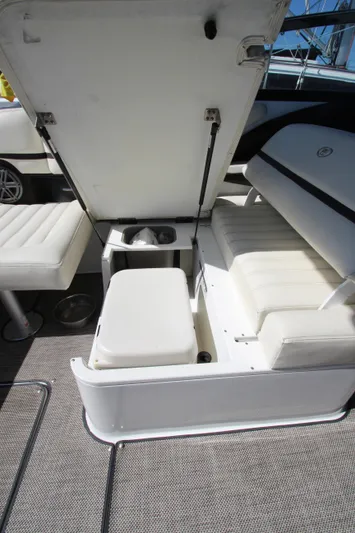  Yacht Photos Pics 2016 Cobalt R30 boat interior with open storage compartment and white seating.