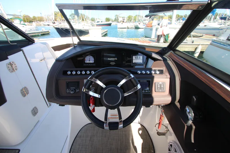  Yacht Photos Pics 2016 Cobalt R30 boat dashboard with steering wheel, gauges, and marina view.
