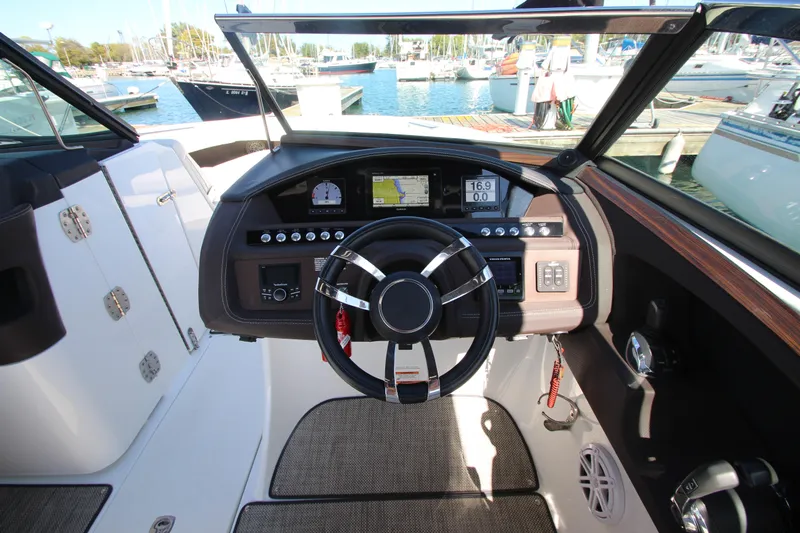  Yacht Photos Pics 2016 Cobalt R30 boat dashboard with steering wheel, controls, and navigation display at marina.