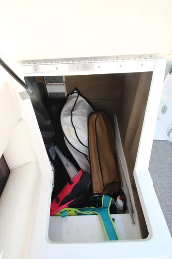  Yacht Photos Pics Storage compartment in a 2016 Cobalt R30 boat, containing various bags and equipment.