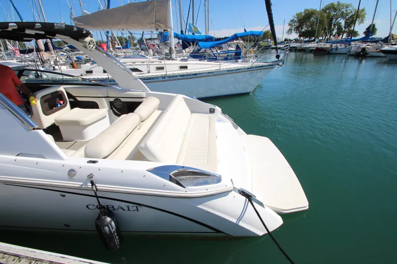  Yacht Photos Pics 2016 Cobalt R30 boat docked in a marina with sailboats in the background.