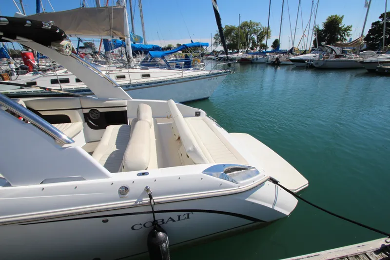  Yacht Photos Pics Cobalt R30 2016 boat docked in a marina with sailboats in the background.