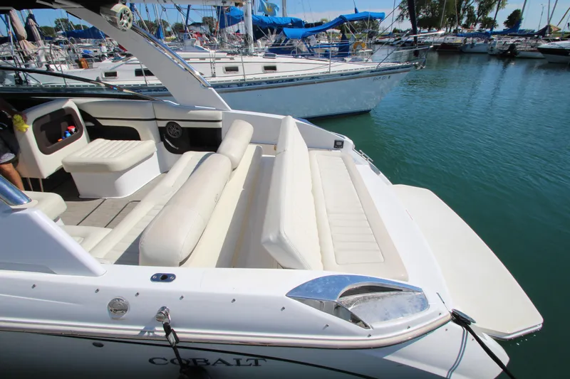  Yacht Photos Pics 2016 Cobalt R30 boat with white seating, docked in a marina.