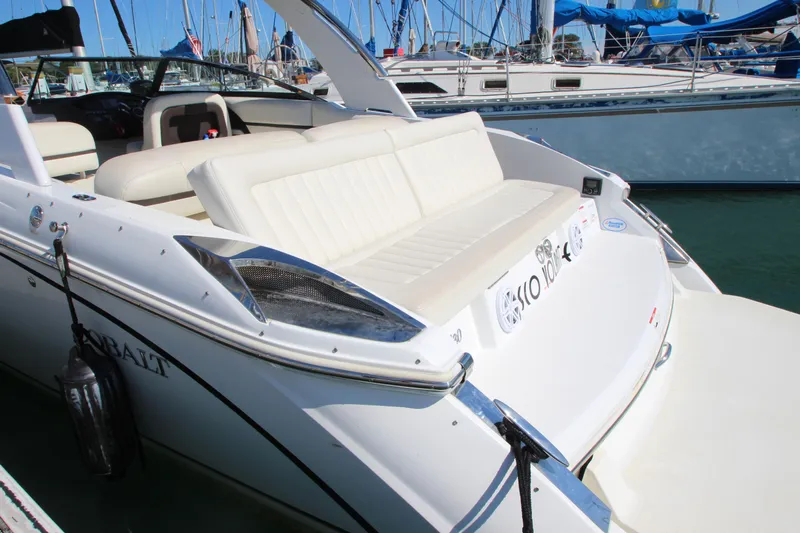  Yacht Photos Pics 2016 Cobalt R30 boat with white seating, docked in a marina.