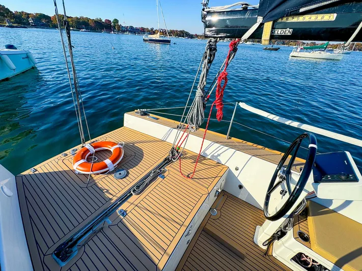 4797ak Yacht Photos Pics Saffier 33 SE sailboat deck with steering wheel and life preserver on calm water.