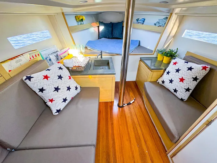4797ak Yacht Photos Pics Interior of 2021 Saffier 33 SE sailboat with cozy seating and star-patterned pillows.