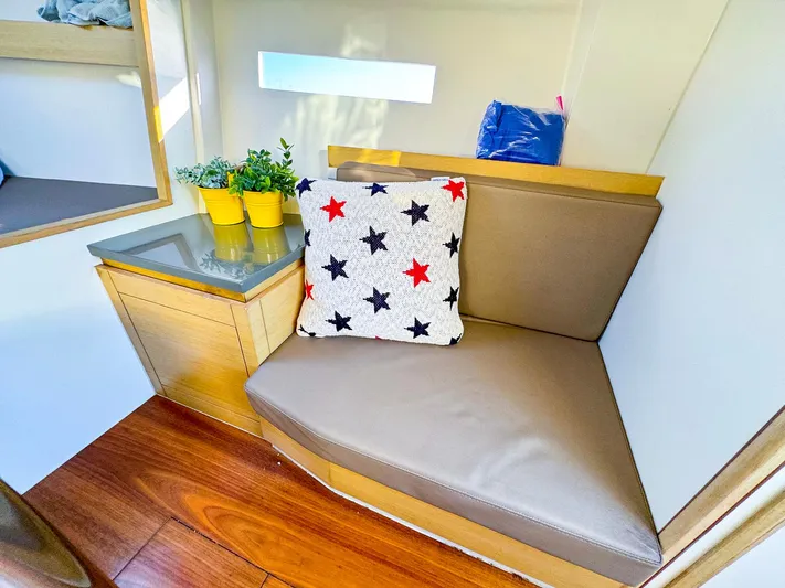 4797ak Yacht Photos Pics Cozy interior of 2021 Saffier 33 SE with star-patterned cushion and potted plants.