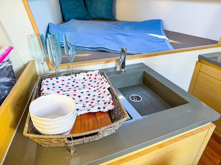 4797ak Yacht Photos Pics Modern Saffier 33 SE yacht interior with sink, dishes, and cozy bedding, 2021 model.