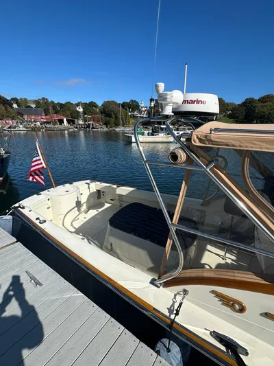 Golden Gate Yacht Photos Pics Hinckley T29 Express 1997 docked by a scenic waterfront with clear blue skies.