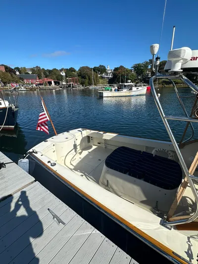 Golden Gate Yacht Photos Pics 1997 Hinckley T29 Express docked by a scenic waterfront with clear blue skies.