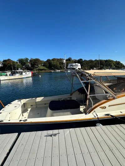 Golden Gate Yacht Photos Pics 1997 Hinckley T29 Express docked by a scenic waterfront under clear blue skies.