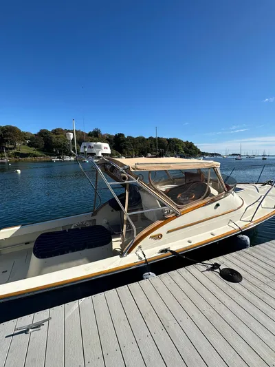 Golden Gate Yacht Photos Pics 1997 Hinckley T29 Express boat docked by a scenic waterfront.