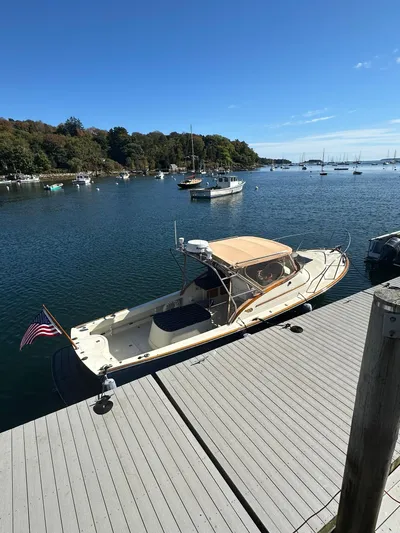 Golden Gate Yacht Photos Pics 1997 Hinckley T29 Express docked in a serene marina with clear blue skies.