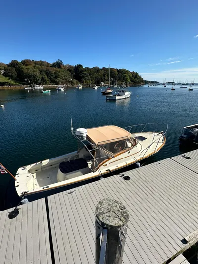 Golden Gate Yacht Photos Pics Hinckley T29 Express 1997 docked in a scenic marina with clear blue skies.