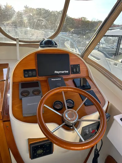 Golden Gate Yacht Photos Pics 1997 Hinckley T29 Express helm with Raymarine navigation system and wooden steering wheel.