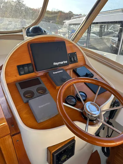 Golden Gate Yacht Photos Pics 1997 Hinckley T29 Express helm with Raymarine electronics and wooden steering wheel.