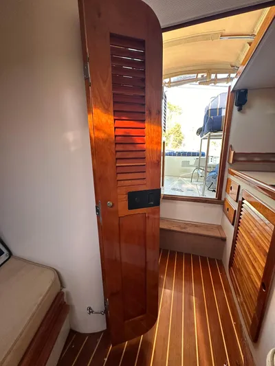 Golden Gate Yacht Photos Pics Interior of 1997 Hinckley T29 Express boat with wooden door and flooring.