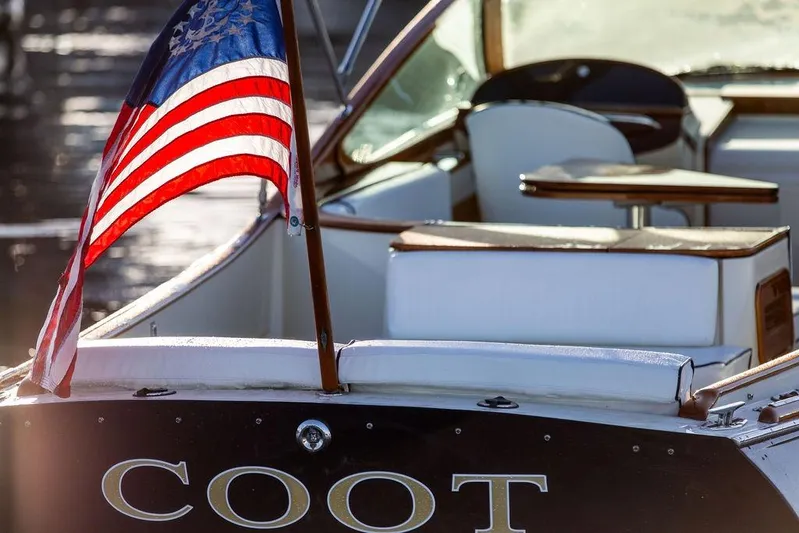 Coot Yacht Photos Pics 2005 Hinckley Talaria 29R boat with American flag, elegant interior, and "COOT" nameplate.