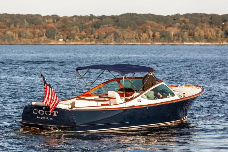 Coot Yacht Photos Pics 2005 Hinckley Talaria 29R boat on water, American flag, scenic background.