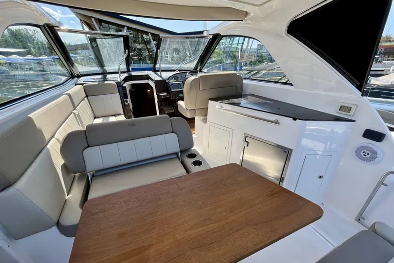  Yacht Photos Pics Interior of 2013 Regal 35 Sport Coupe yacht with seating and table.