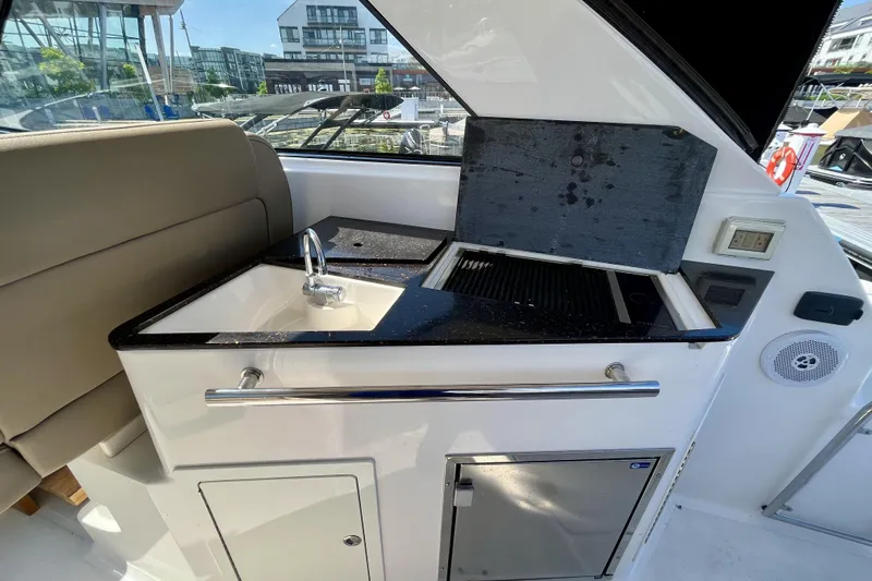  Yacht Photos Pics 2013 Regal 35 Sport Coupe yacht kitchenette with sink and grill.