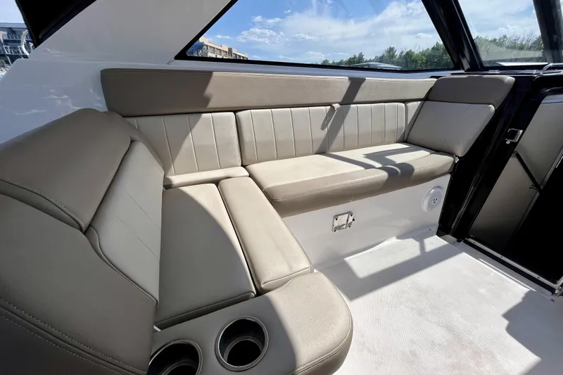  Yacht Photos Pics Luxurious interior seating of 2013 Regal 35 Sport Coupe with beige upholstery and cup holders.