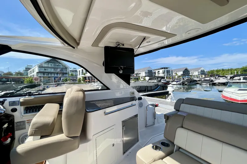  Yacht Photos Pics Interior view of 2013 Regal 35 Sport Coupe at marina, featuring luxurious seating and modern amenities.