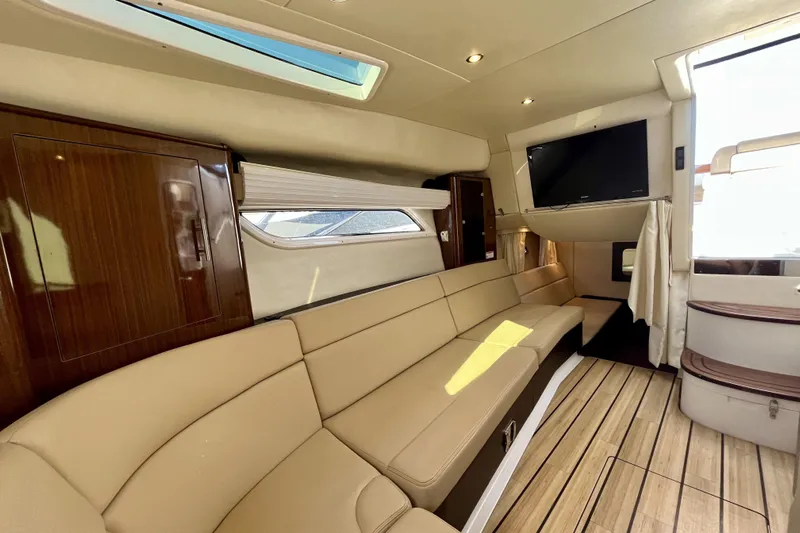  Yacht Photos Pics Luxurious interior of 2013 Regal 35 Sport Coupe with beige seating and wood accents.