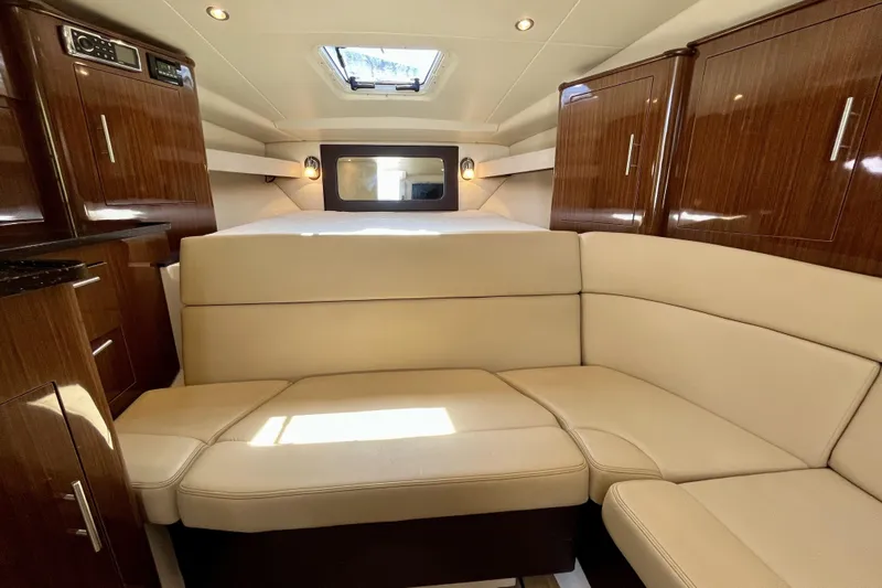  Yacht Photos Pics Luxurious interior of 2013 Regal 35 Sport Coupe with elegant wood cabinetry and plush seating.