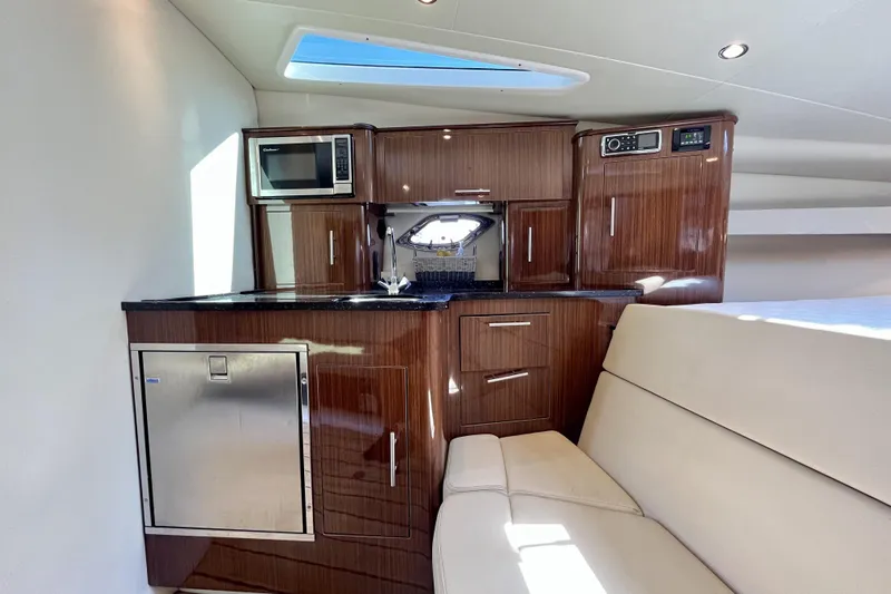  Yacht Photos Pics Luxurious interior of 2013 Regal 35 Sport Coupe with modern kitchenette and seating.