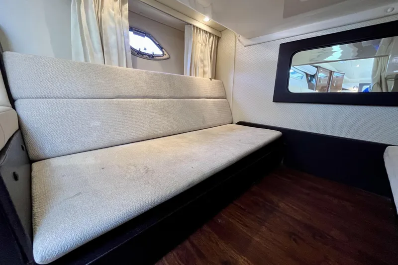  Yacht Photos Pics Interior of 2013 Regal 35 Sport Coupe with beige seating and wooden flooring.